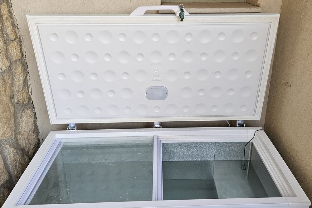 My white chest freezer filled with water, open lid and temperature probe